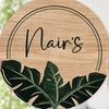 Wooden round sign with 'Nair's' and leaf designs