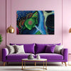 Purple sofa with decorative pillows in a room with a colorful abstract painting on the wall.