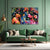 Colorful abstract painting on a green wall above a green sofa.