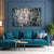 Modern living room with a blue sofa, abstract painting, and decorative items.
