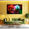 Living room with a green sofa, colorful abstract painting on the wall, and decorative items.