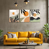 Yellow sofa in a living room with abstract wall art and plants.