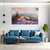 Modern living room with a blue sofa, coffee table, and wall art of a lavender field.