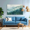 Modern living room with a blue sofa, wooden coffee table, and nature-themed wall art.