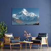 Living room with a mountain painting on the wall, two chairs, and a coffee table.