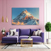 Living room with a purple sofa, mountain painting, and decorative elements.