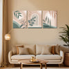 Living room with a beige sofa, decorative pillows, and wall art featuring abstract leaf designs.