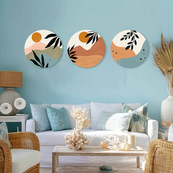 Three circular wall art pieces on a blue wall above a white sofa with decorative pillows.