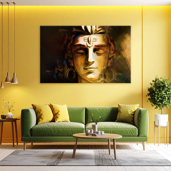 Living room with a green sofa, coffee table, and large wall art of a golden face.