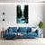 Modern living room with a blue sofa, coffee table, and wall art of a nature scene.