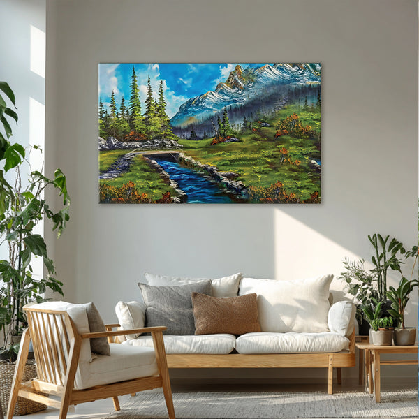 Landscape painting of a mountain scene above a living room with a sofa and chair.