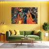 Living room with a green sofa, coffee table, and a large wall art of two figures playing music on a yellow wall.