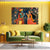 Living room with a green sofa, coffee table, and a large wall art of two figures playing music on a yellow wall.
