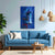 Living room with a blue sofa, abstract painting, and wooden coffee table.