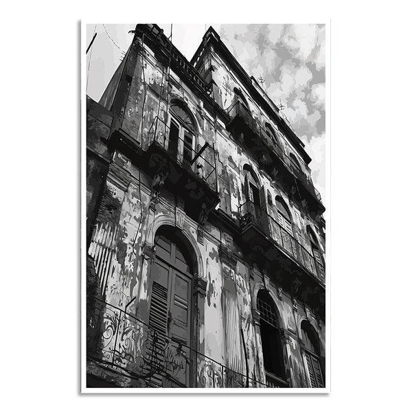 Black and white photograph of an old, weathered building with balconies against a cloudy sky.