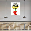 Poster with a red apple and face design on a wall in a modern cafe setting.