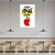 Poster with a red apple and face design on a wall in a modern cafe setting.