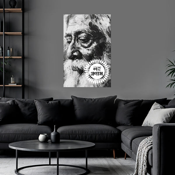 Black and white portrait of a revered figure on a wall above a dark gray sofa in a living room.