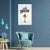 Modern living room with a blue armchair, small table, and decorative wall art.
