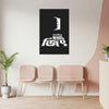 Black poster with white text on a wall above three pink chairs in a room.