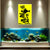 Aquarium with fish and a yellow sign with black text on a wall above it.
