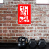Black kettlebell and dumbbells against a brick wall with a red and white logo above.