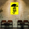 Yellow poster with black text and an umbrella on a textured wall above wooden chairs.