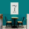 Small dining area with a table and two chairs against a teal wall, featuring a decorative sign.