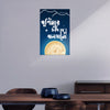 Decorative wall poster with a moon and text on a blue background, displayed in a room.