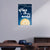 Decorative wall poster with a moon and text on a blue background, displayed in a room.