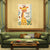 Decorative wall art of a giraffe with text above a green sofa in a living room.