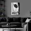 Abstract art piece on a wall above a black sofa in a living room.