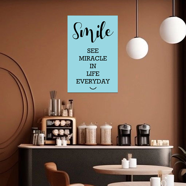 Motivational poster with 'Smile, see miracle in life everyday' quote in a coffee shop setting.