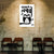 Poster with an owl design and text on a textured wall in a room with wooden chairs and tables.