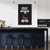 Modern kitchen with a black wall featuring white and red text and graphics.
