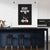 Modern kitchen with a black wall featuring white and red text and graphics.