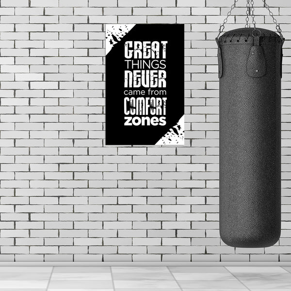 Motivational poster with quote next to a punching bag against a brick wall.