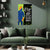Living room with a green sofa and decorative wall art featuring a stylized figure and text.