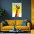 Yellow sofa with decorative pillows in a living room setting, featuring a colorful poster on the wall.