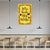Decorative wall art with text and hearts on a yellow background in a modern cafe setting.