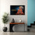 Decorative wall art of a seated figure with text on a wall above a table with decorative items.