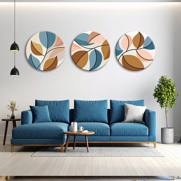 Modern living room with a blue sofa, decorative wall art, and a small table.