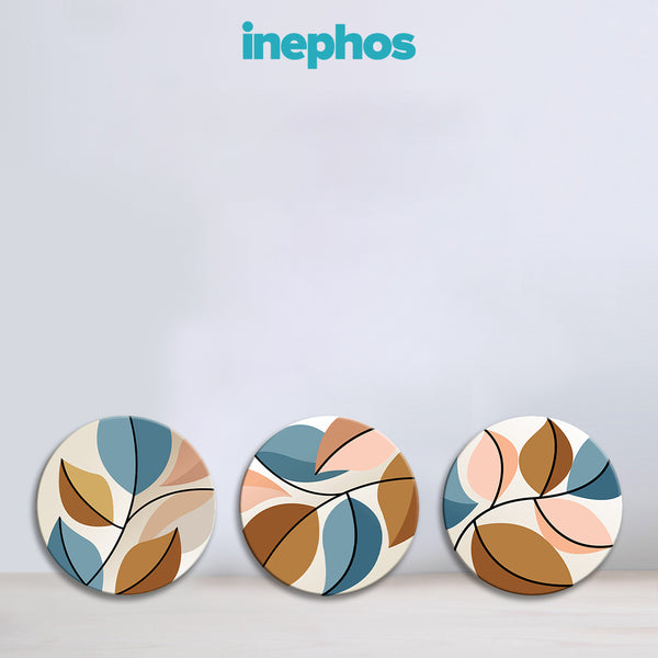 Three circular coasters with leaf patterns on a light gray background, featuring the brand 'inephos'.