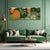 Green living room with a green sofa, decorative table, and wall art featuring orange and green elements.