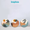 Three circular coasters with artistic designs on a light gray background, featuring the brand 'inephos'.