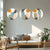 Three circular wall art pieces above a sofa in a living room.