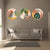 Three circular wall art pieces with leaf designs above a gray sofa in a living room.