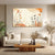 Living room with a beige sofa, wooden coffee table, and abstract wall art.