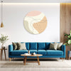 Modern living room with a blue sofa, round coffee table, and abstract wall art.