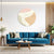 Modern living room with a blue sofa, round coffee table, and abstract wall art.